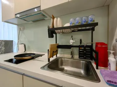 a kitchen counter with a sink and a stove at Setapak Central KL - Zetapark Spring Suites in Kuala Lumpur