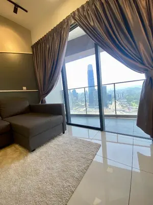 a living room with a couch and a large window at TOP FLOOR 3BR apartment in KL for 6Pax in Kuala Lumpur