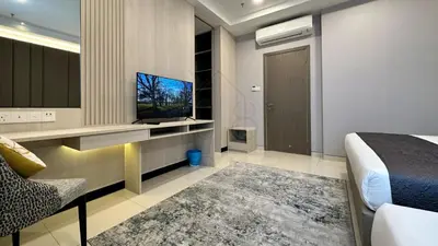 a hotel room with a bed and a television at Societe Suites 108 Hartamas Mont Kiara Kuala Lumpur 2-6pax in Kuala Lumpur