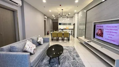 a living room with a couch and a large screen television at Societe Suites 108 Hartamas Mont Kiara Kuala Lumpur 2-6pax in Kuala Lumpur
