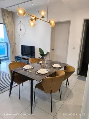 a dining table and chairs in a living room at Trion by sweet home in Kuala Lumpur