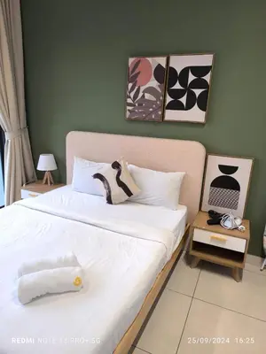 a bedroom with a large bed with white sheets at Trion by sweet home in Kuala Lumpur