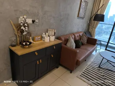 a living room with a couch and a table at Trion by sweet home in Kuala Lumpur