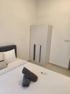 a stuffed animal laying on a bed in a room at Trion By Awesome Apartment Stay in Kuala Lumpur