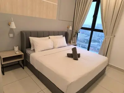 a bedroom with a bed with a teddy bear on it at Trion By Awesome Apartment Stay in Kuala Lumpur