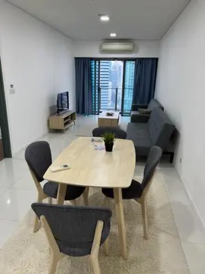 a wooden table and chairs in a living room at Summer Suites KLCC in Kuala Lumpur