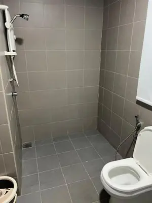 a bathroom with a toilet and a shower at Summer Suites KLCC in Kuala Lumpur