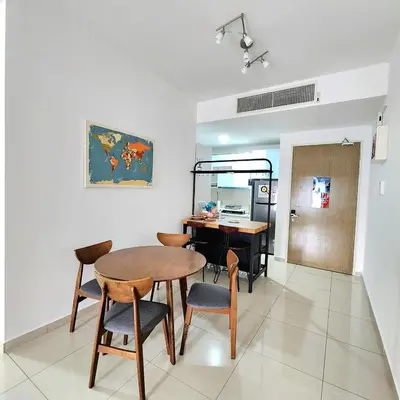 a dining room with a table and chairs at KLCC Skyhomes near LRT in Kuala Lumpur