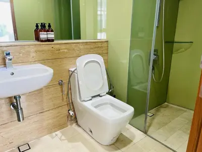 a bathroom with a toilet and a sink and a shower at Vortex Hotel Suites & Residence by KLCC in Kuala Lumpur