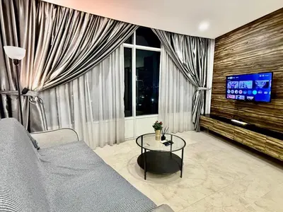 a living room with a couch and a tv at Vortex Hotel Suites & Residence by KLCC in Kuala Lumpur