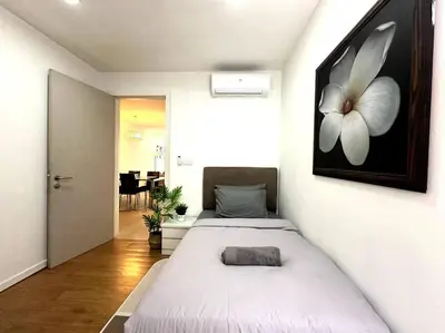 a bedroom with a bed with a flower painting on the wall at Bintang Fairlane Residence, KLCC & City View - 2B1R in Kuala Lumpur