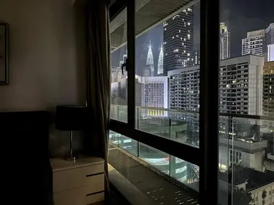 a view of a city skyline from a window at Bintang Fairlane Residence, KLCC & City View - 2B1R in Kuala Lumpur