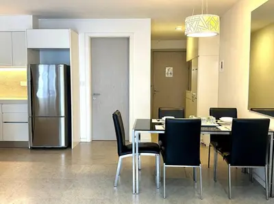 a dining room with a table and a refrigerator at Bintang Fairlane Residence, KLCC & City View - 2B1R in Kuala Lumpur