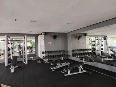 a gym with a large mirror and lots of machines at Swiss Garden Bukit Bintang in Kuala Lumpur