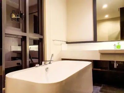 a white tub in a bathroom with a sink at The Mews KLCC by GBS in Kuala Lumpur