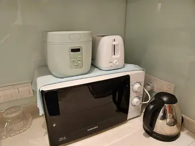 a microwave sitting on top of a kitchen counter at V Residence Suite at Sunway Velocity in Kuala Lumpur