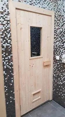 a wooden door with a window in a brick wall at V Residence Suite at Sunway Velocity in Kuala Lumpur