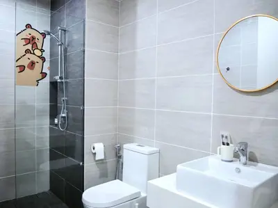 a bathroom with a toilet and a sink and a mirror at Capybara Trion KL View in Kuala Lumpur