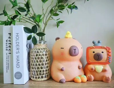 two toy bears sitting on a table next to a vase at Capybara Trion KL View in Kuala Lumpur