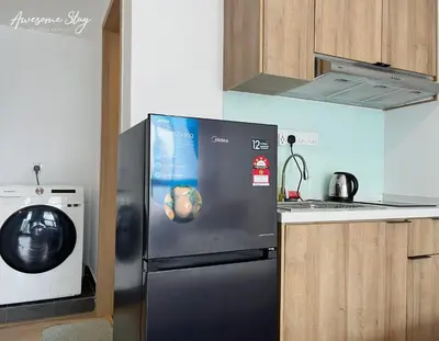 a kitchen with a refrigerator and a washing machine at Colony Infinitum By NJ Homes in Kuala Lumpur