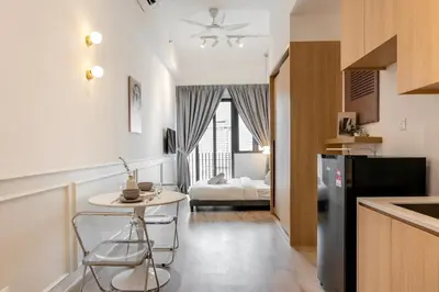 a kitchen with a small table and a room with a bed at Colony Infinitum By NJ Homes in Kuala Lumpur