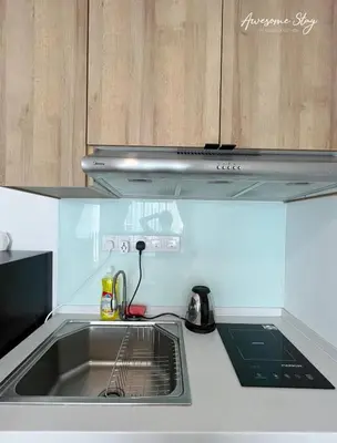 a kitchen counter with a sink and a microwave at Colony Infinitum By NJ Homes in Kuala Lumpur