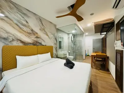 a bedroom with a large white bed and a bathroom at Awesomestay apartment walk to Tun Sambathan near KL Sentral in Kuala Lumpur