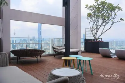 a balcony with tables and chairs on a building at Awesomestay apartment walk to Tun Sambathan near KL Sentral in Kuala Lumpur