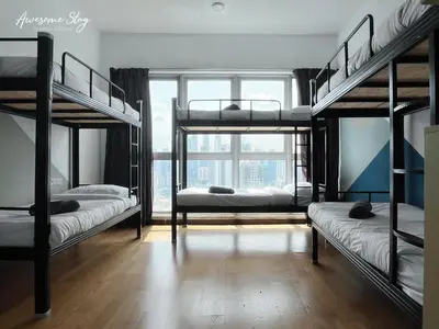 a room with four bunk beds and a window at NJ Homestay Hostel at Regalia Residence in Kuala Lumpur