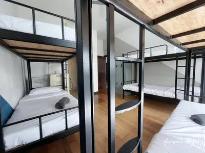 a room with four bunk beds in it at NJ Homestay Hostel at Regalia Residence in Kuala Lumpur
