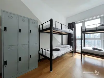 a bedroom with two bunk beds and a window at NJ Homestay Hostel at Regalia Residence in Kuala Lumpur