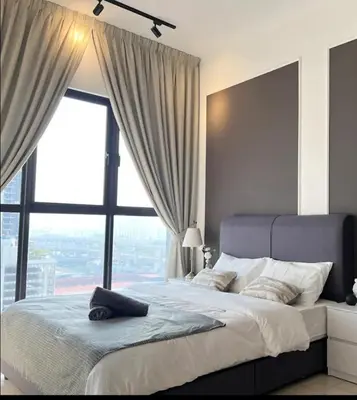 a bedroom with a large bed with a large window at trion2 klcc in Kuala Lumpur
