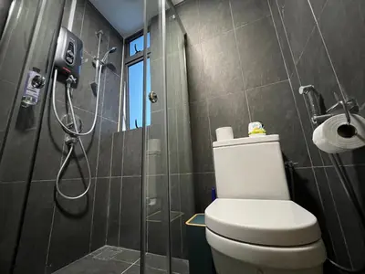 a bathroom with a shower and a toilet in it at The Colony By Infinitum KLCC in Kuala Lumpur