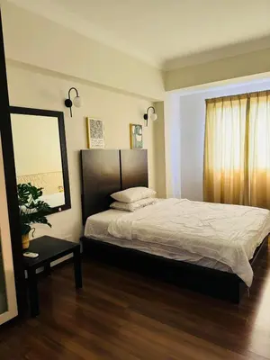 a bedroom with a large bed and a mirror at Homestay Room near KLCC in Kuala Lumpur