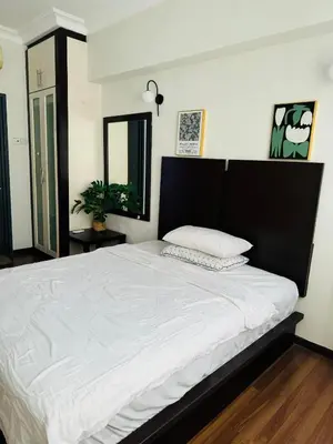 a bedroom with a large bed with white sheets at Homestay Room near KLCC in Kuala Lumpur