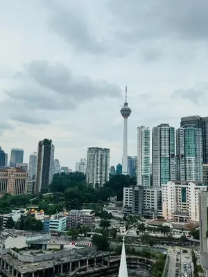 a view of a city with a tower in the background at Homestay Room near KLCC in Kuala Lumpur