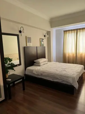 a bedroom with a large bed and a mirror at Homestay Room near KLCC in Kuala Lumpur