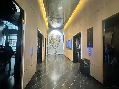 a hallway of a building with a painting on the wall at Holiday Suites at Star in Kuala Lumpur