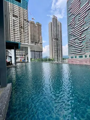 a large pool of water in a city with tall buildings at Dreamscape By Reizz Residence in Kuala Lumpur