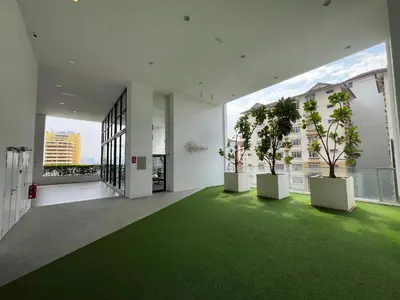 a room with green carpet and two trees in it at Dreamscape By Reizz Residence in Kuala Lumpur