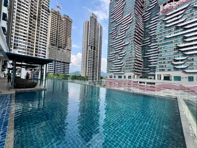 a large swimming pool in a city with tall buildings at Dreamscape By Reizz Residence in Kuala Lumpur