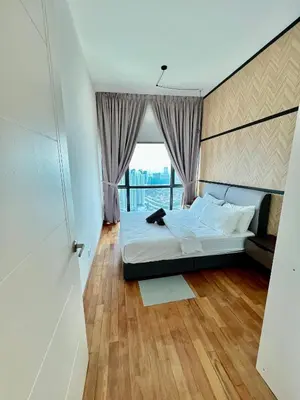 a bedroom with a bed and a large window at Dreamscape By Reizz Residence in Kuala Lumpur