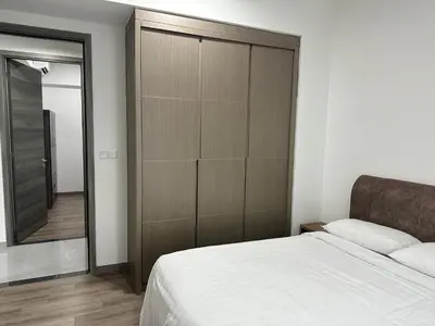 a bedroom with a bed and a large closet at Agile Residence Bukit Bintang TRX By SweetHome in Kuala Lumpur