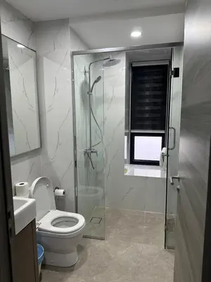 a bathroom with a toilet and a glass shower at Agile Residence Bukit Bintang TRX By SweetHome in Kuala Lumpur