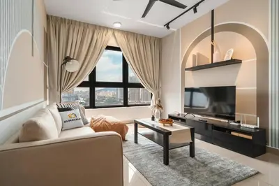 a living room with a couch and a tv at 4BR Modish Room MVertica Near MRT by RumaBnB in Kuala Lumpur