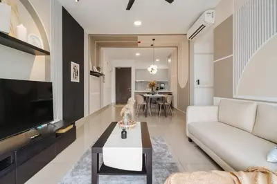 a living room with a white couch and a tv at 4BR Modish Room MVertica Near MRT by RumaBnB in Kuala Lumpur