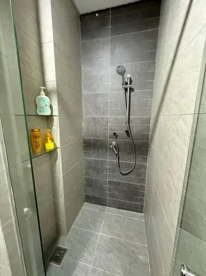 a bathroom with a shower with a glass door at Vivo Soho Suite-5pax-Next to Midvalley, KL center in Kuala Lumpur