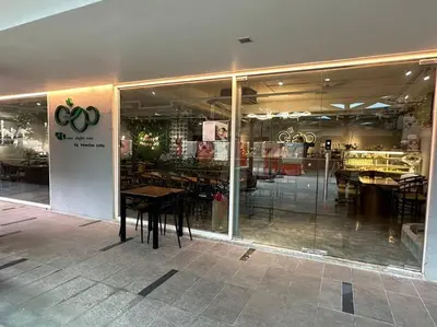 a restaurant with tables and chairs in front of a window at Vivo Soho Suite-5pax-Next to Midvalley, KL center in Kuala Lumpur