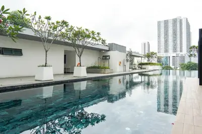 a swimming pool in the middle of a building at Vivo Soho Suite-5pax-Next to Midvalley, KL center in Kuala Lumpur