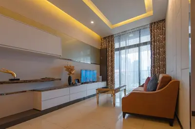 a living room with a couch and a television at 1-6pax Dorsett KL 3mins to Pavilion Infinity Pool in Kuala Lumpur